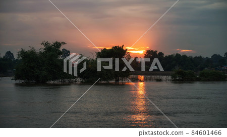 orange sunrise through cloudy sky with reflect on lake 84601466