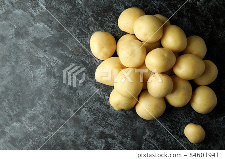 Tasty young potato on black smokey background 84601941