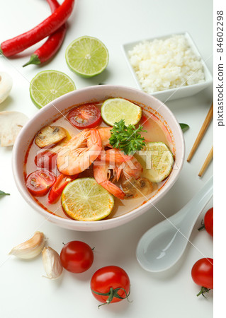 Tom yum soup and ingredients on white background Tom yum soup and ingredients on white background 84602298