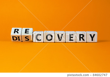 Recovery or discovery symbol. Turned a wooden cube, changed a word 'discovery' to 'recovery'. Beautiful orange background. Business and discovery or recovery concept. Copy space. 84602747