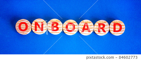 Onboard and onboarding symbol. The concept word Onboard on wooden circles. Beautiful blue background, copy space. Business onboard and onboarding concept. 84602773