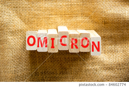 Covid-19 new omicron strain symbol. The concept word Omicron on wooden blocks. Beautiful canvas background. Copy space. Medical and COVID-19 new omicron strain variant virus concept. 84602774