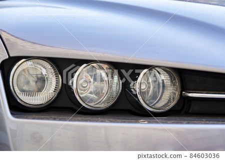 Headlight with halogen lamp on modern car, closeup Headlight with halogen lamp on modern car, closeup 84603036