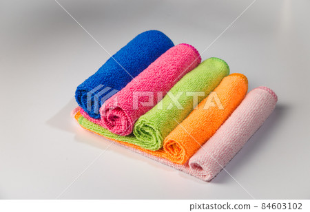 woman's hand polishing the door of mahogany kitchen closet 84603102