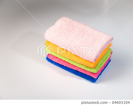 woman's hand polishing the door of mahogany kitchen closet 84603104