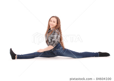 Girl in jeans sitting on twine 84604100