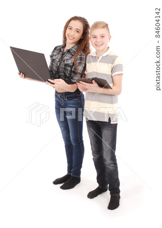 Two kids playing and surfing the web on digital tablet and laptop. 84604142