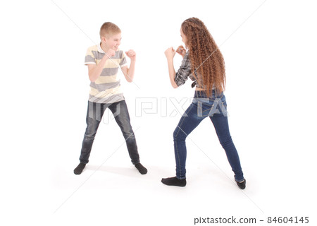 Boy and girl boxing. Two angry children. Boy and girl boxing. Two angry children. 84604145