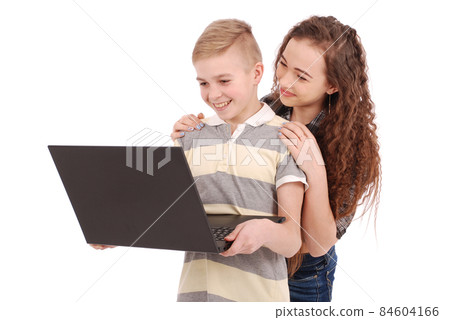 Boy and girl using a laptop isolated 84604166