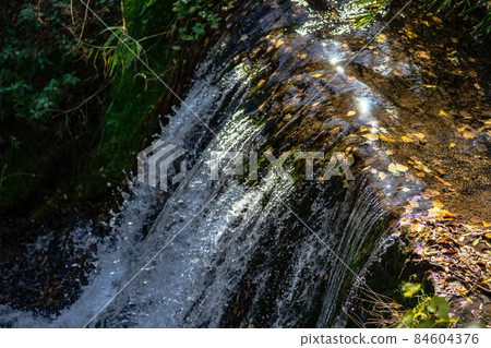 Waterfall with stream running river 84604376