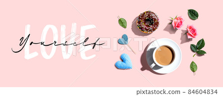 Love Yourself message with a cup of coffee and a donut 84604834
