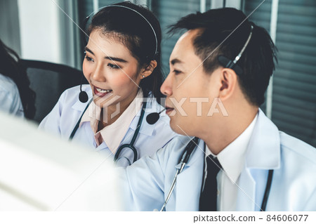 Doctor team wearing headset talking actively on video call in hospital clinic 84606077