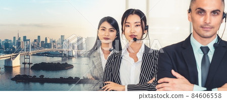 Business people wearing headset working in office broaden view Business people wearing headset working in office broaden view 84606558