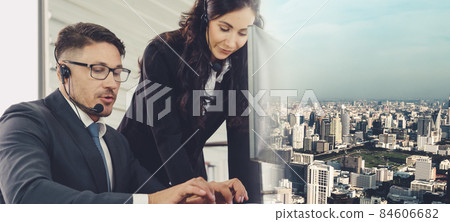 Business people wearing headset working in office broaden view Business people wearing headset working in office broaden view 84606682