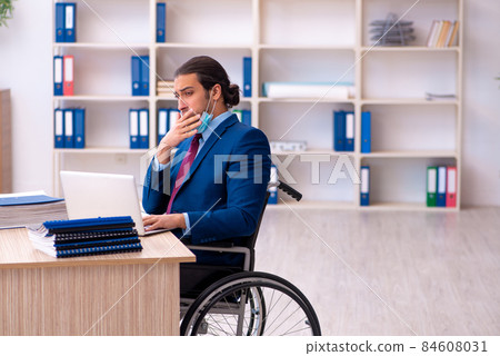 Young disabled employee during pandemic at workplace Young disabled employee during pandemic at workplace 84608031