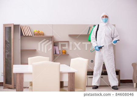 Young male contractor disinfecting at home 84608046