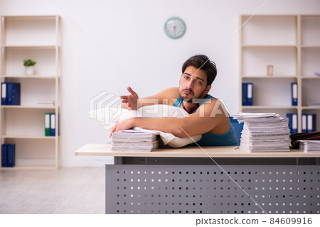 Young male employee coming to work straight from bed 84609916