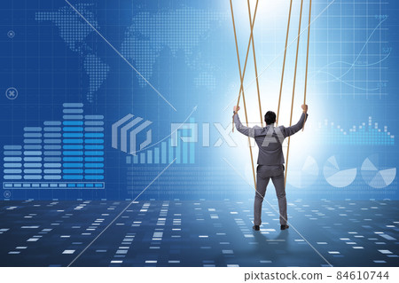 Businessman puppet being manipulated by ropes 84610744