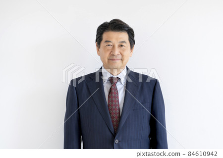 A businessman in his 60s smiling looking at the camera A businessman in his 60s smiling looking at the camera 84610942
