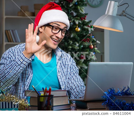 Young man working at home on christmas day 84611004
