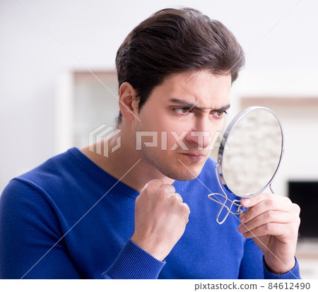 Man panicking because of pimples on the skin 84612490
