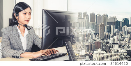 Business people wearing headset working in office broaden view Business people wearing headset working in office broaden view 84614420