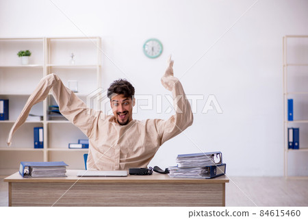 Crazy young man in straitjacket at the office 84615460