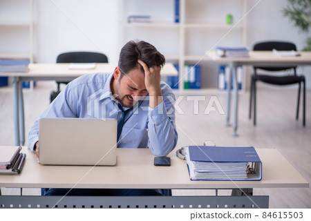 Young male employee working in the office Young male employee working in the office 84615503