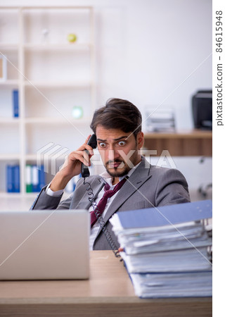 Young male employee working in the office 84615948