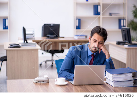 Young male employee working in the office Young male employee working in the office 84616026