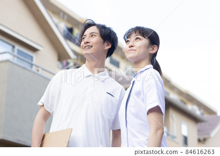 Medical staff standing in a residential area 84616263