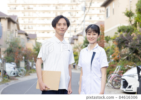Medical staff standing in a residential area Medical staff standing in a residential area 84616306