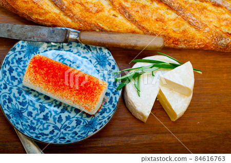 French cheese and fresh baguette on a wood cutter French cheese and fresh baguette on a wood cutter 84616763