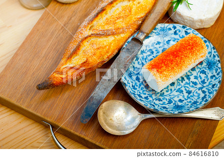 French cheese and fresh baguette on a wood cutter French cheese and fresh baguette on a wood cutter 84616810
