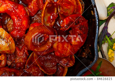 fresh seafoos stew on an iron skillet 84616815