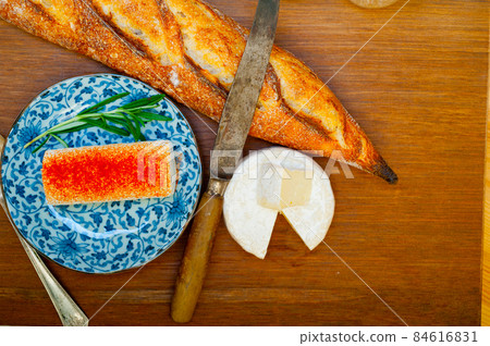 French cheese and fresh  baguette on a wood cutter 84616831