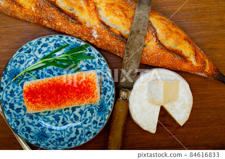 French cheese and fresh baguette on a wood cutter French cheese and fresh baguette on a wood cutter 84616833