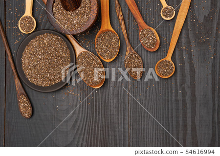Bowl of organic natural chia seeds close-up on wooden background or table 84616994