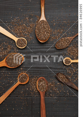 Bowl of organic natural chia seeds close-up on wooden background or table 84616995