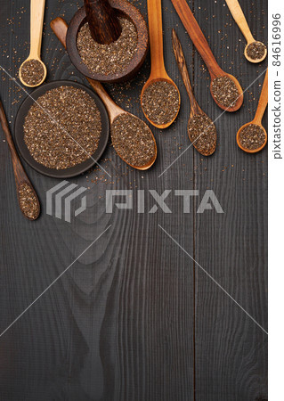 Bowl of organic natural chia seeds close-up on wooden background or table 84616996