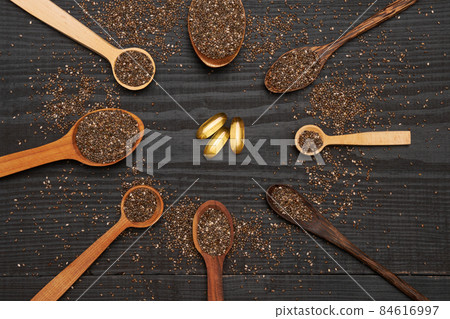 Organic natural chia seeds and wooden scoop close-up on wooden background or table 84616997