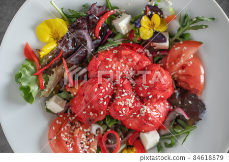 Italian coffee maker with wooden handle and white coffee craft cup on solid wood stamp decorated with tea towels in creamy tones on sunlight creating beautiful shadows on the wall 84618879