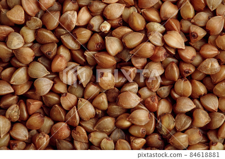Italian coffee maker with wooden handle and white coffee craft cup on solid wood stamp decorated with tea towels in creamy tones on sunlight creating beautiful shadows on the wall 84618881