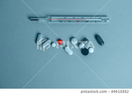 Italian coffee maker with wooden handle and white coffee craft cup on solid wood stamp decorated with tea towels in creamy tones on sunlight creating beautiful shadows on the wall 84618882