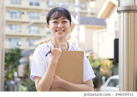 Medical staff standing in a residential area 84620431