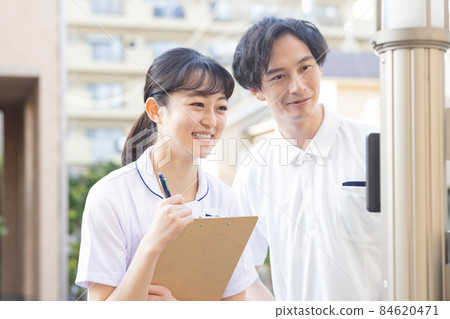 Medical staff standing in a residential area 84620471