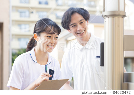 Medical staff standing in a residential area 84620472
