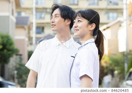 Medical staff standing in a residential area Medical staff standing in a residential area 84620485