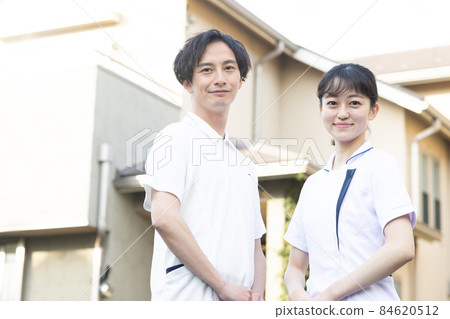 Medical staff standing in a residential area Medical staff standing in a residential area 84620512