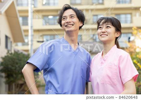 Medical staff standing in a residential area Medical staff standing in a residential area 84620648